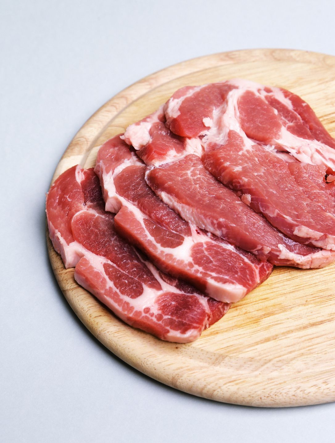 Slices Of Raw Meat On A Wooden Cutting Board — Start Fresh Fruit Market in Bundaberg Central QLD