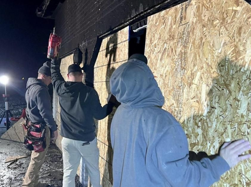 ClassONE crew boarding up a fire-damaged building at night to prevent further damage