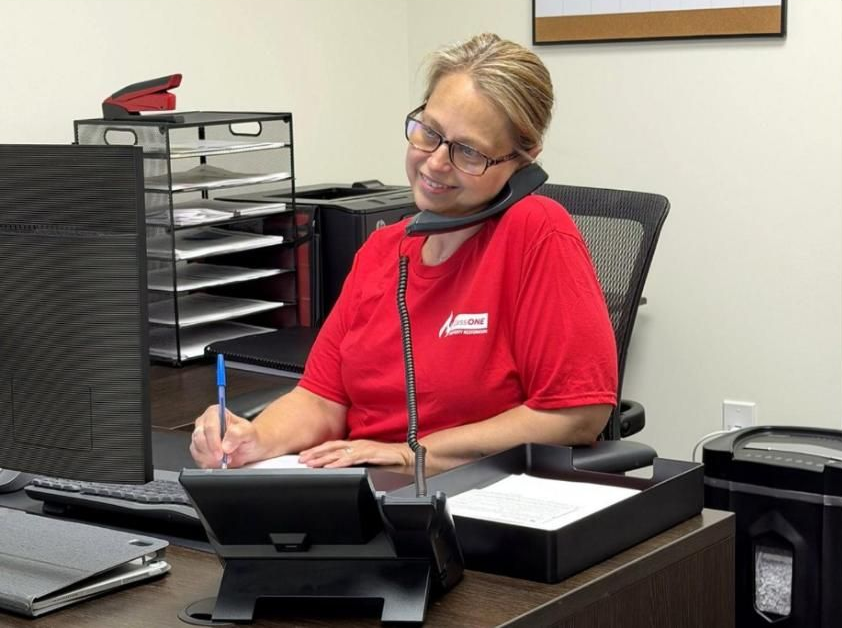 ClassONE team member on the phone with a customer, helping coordinate the insurance claim process