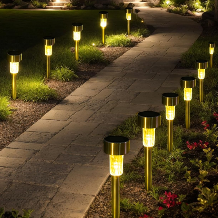 Curved garden path lit by small solar lanterns at night