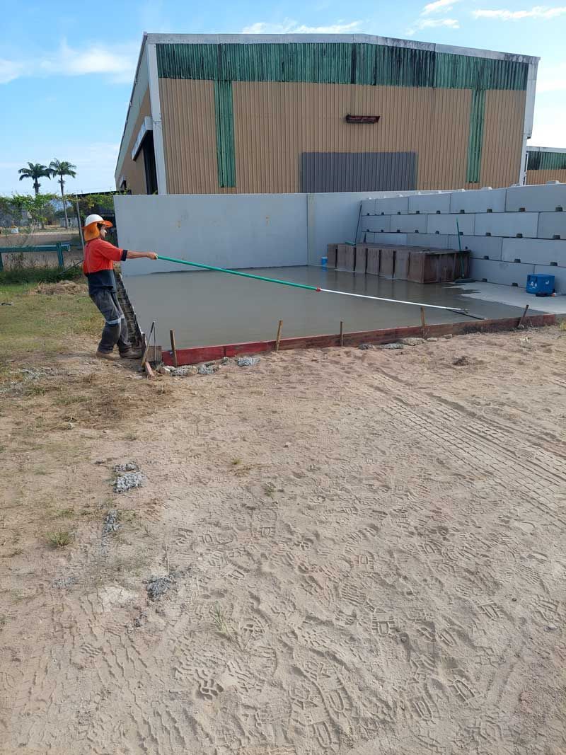 A Man Is  Finishing The Concrete Flooring — Ingham Concrete–Icon in Ingham, QLD