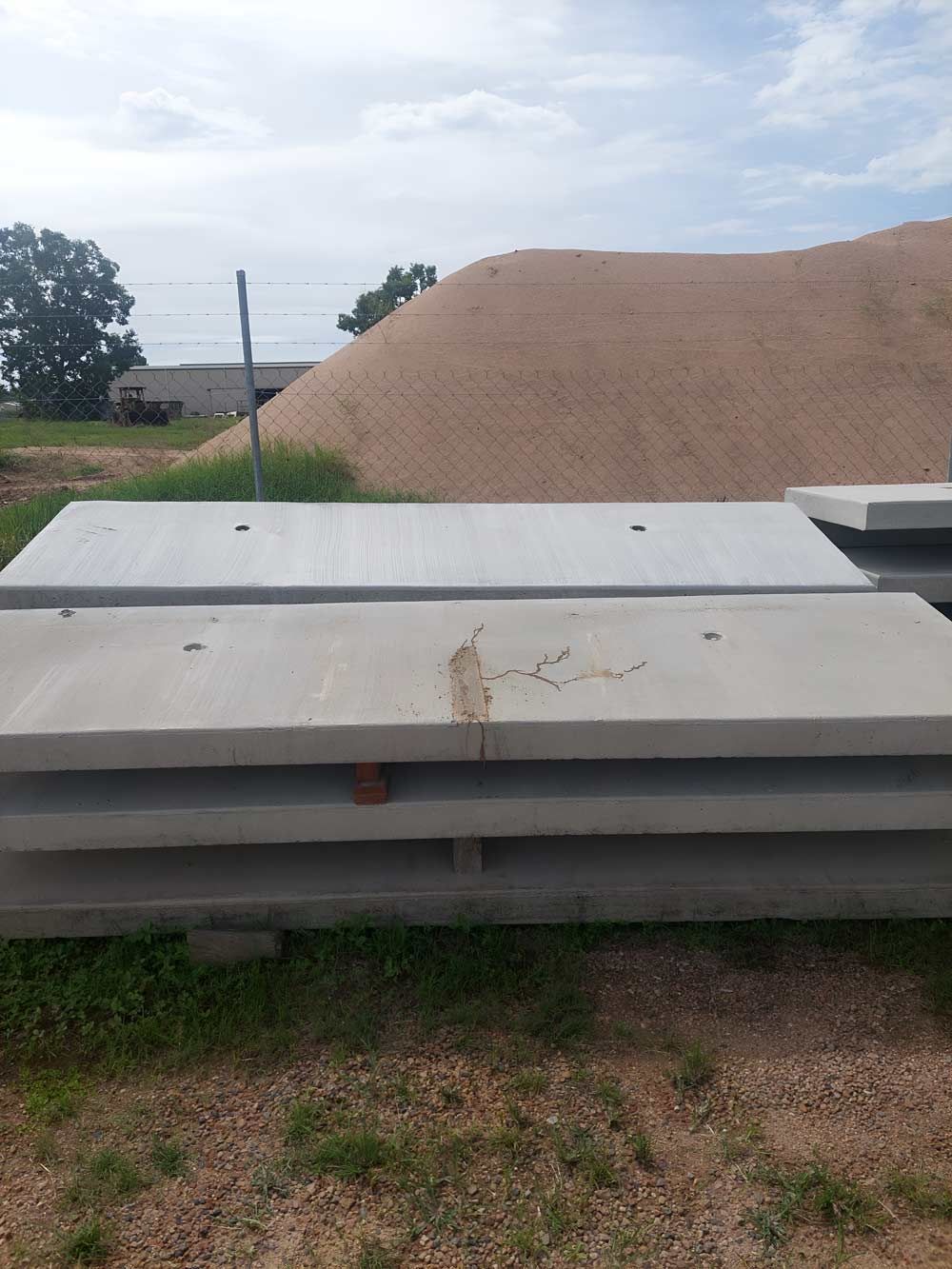 Pile Of Concrete Slabs Is Placed In The Grass — Ingham Concrete–Icon in Ingham, QLD