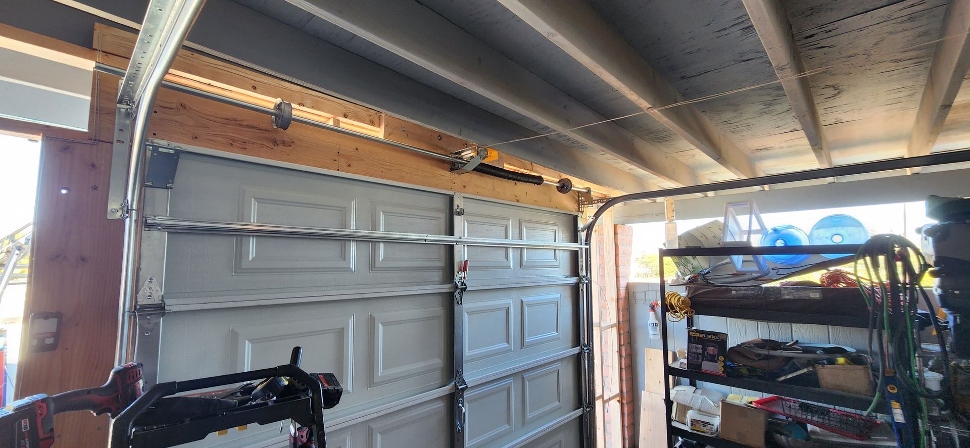 A garage with a garage door open and a bicycle in it.