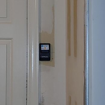 A close up of a door with a remote control on it.