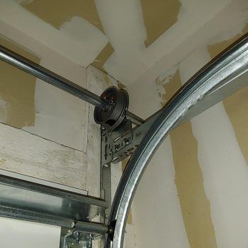 A close up of a garage door roller in a garage.