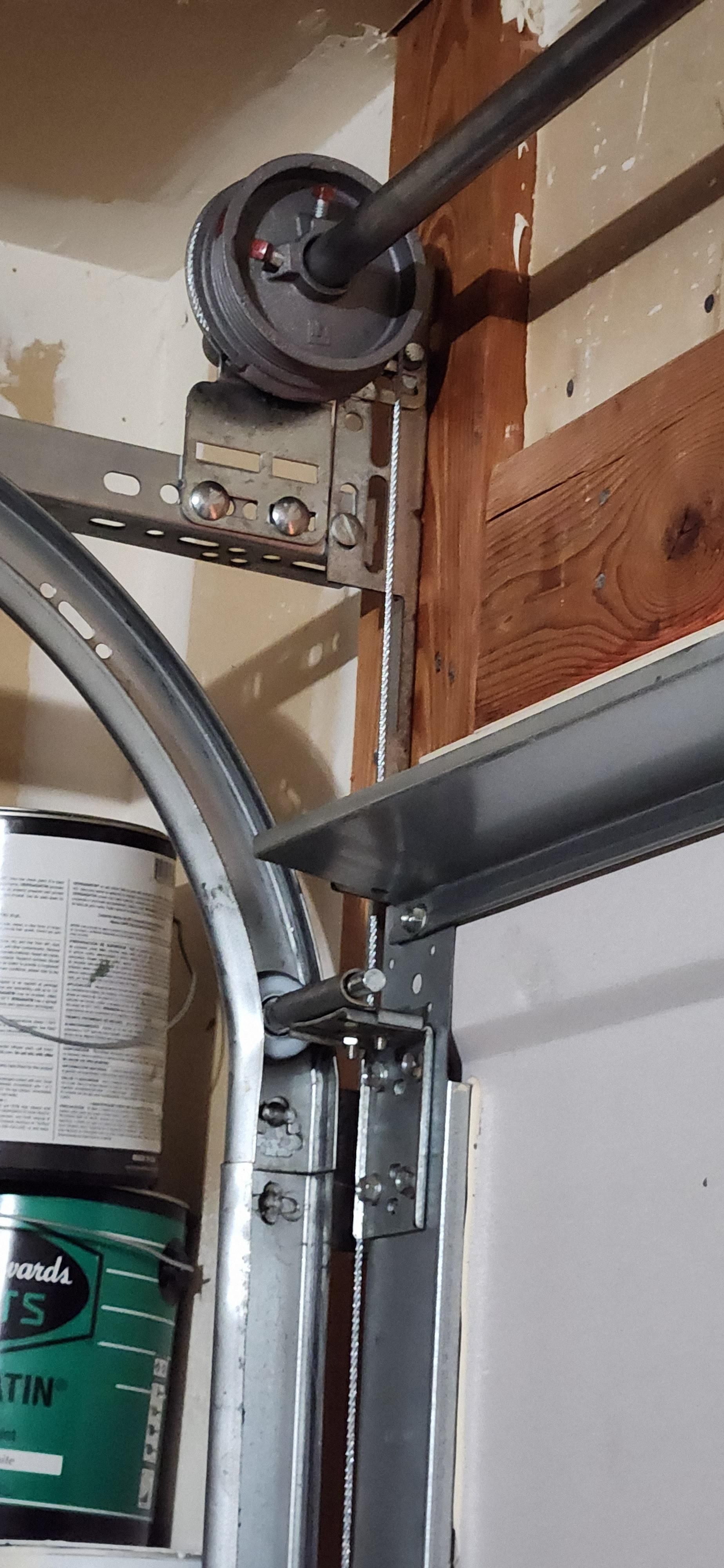A close up of a garage door with a roller on it.