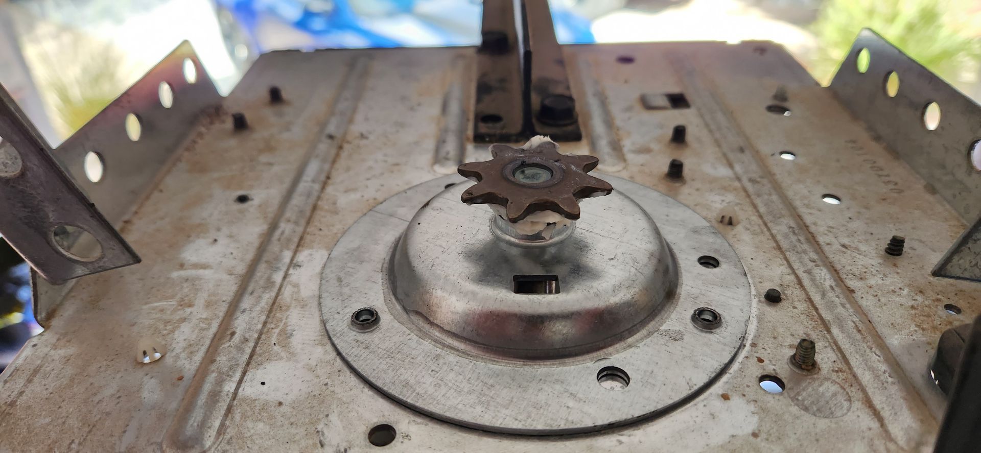 A close up of a metal object with a gear on top of it.