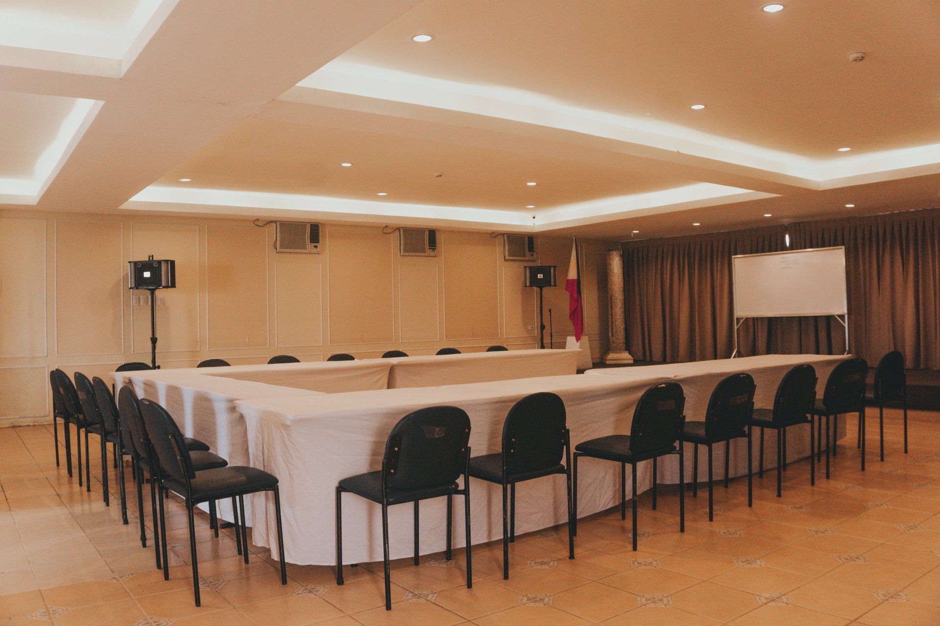 A large conference room with a long table and chairs.