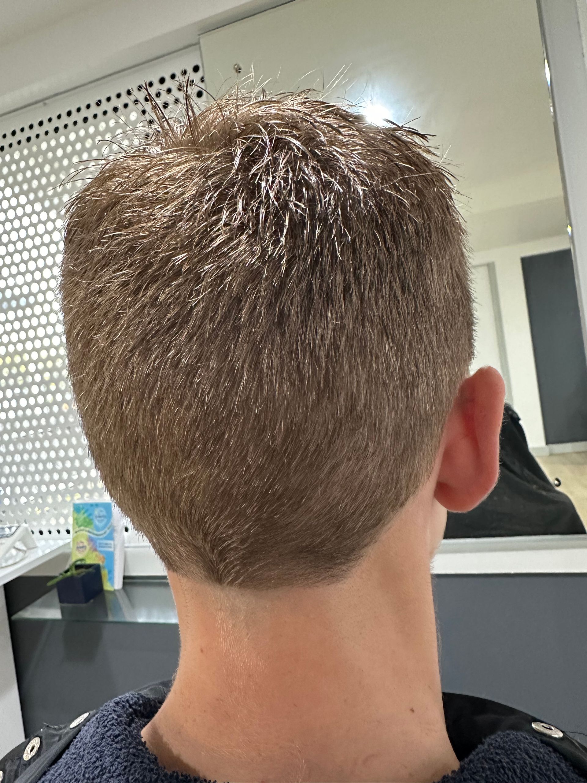 A Man is Getting His Hair Cut by a Barber in a Salon — Azure Hair in South Mackay, QLD