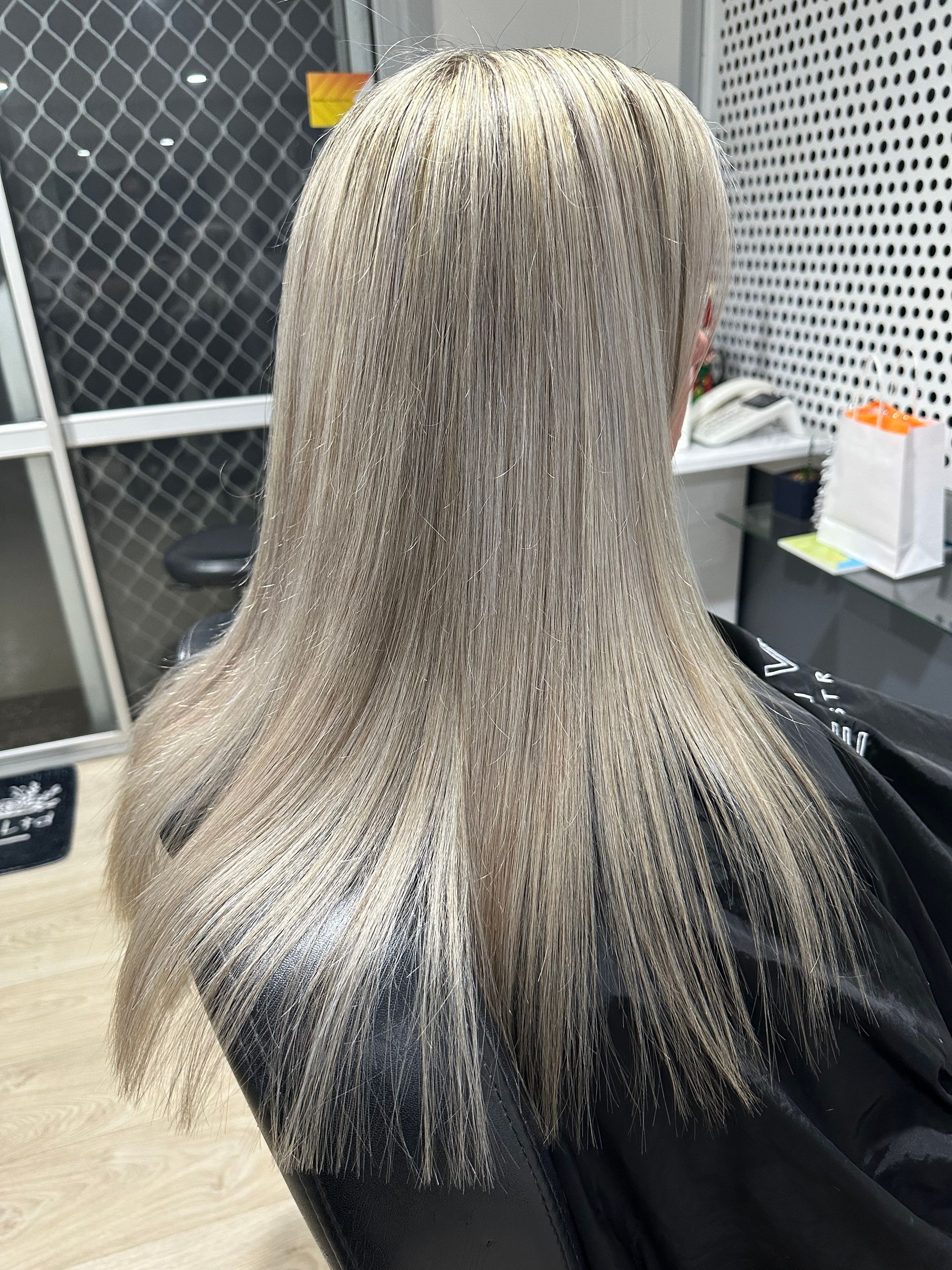 A Woman With Blonde Hair sitting in the Salon Chair— Azure Hair in South Mackay, QLD