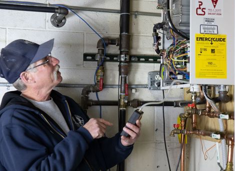 A plumber is fixing a sink with a wrench. Plumber Royal Oak Michigan