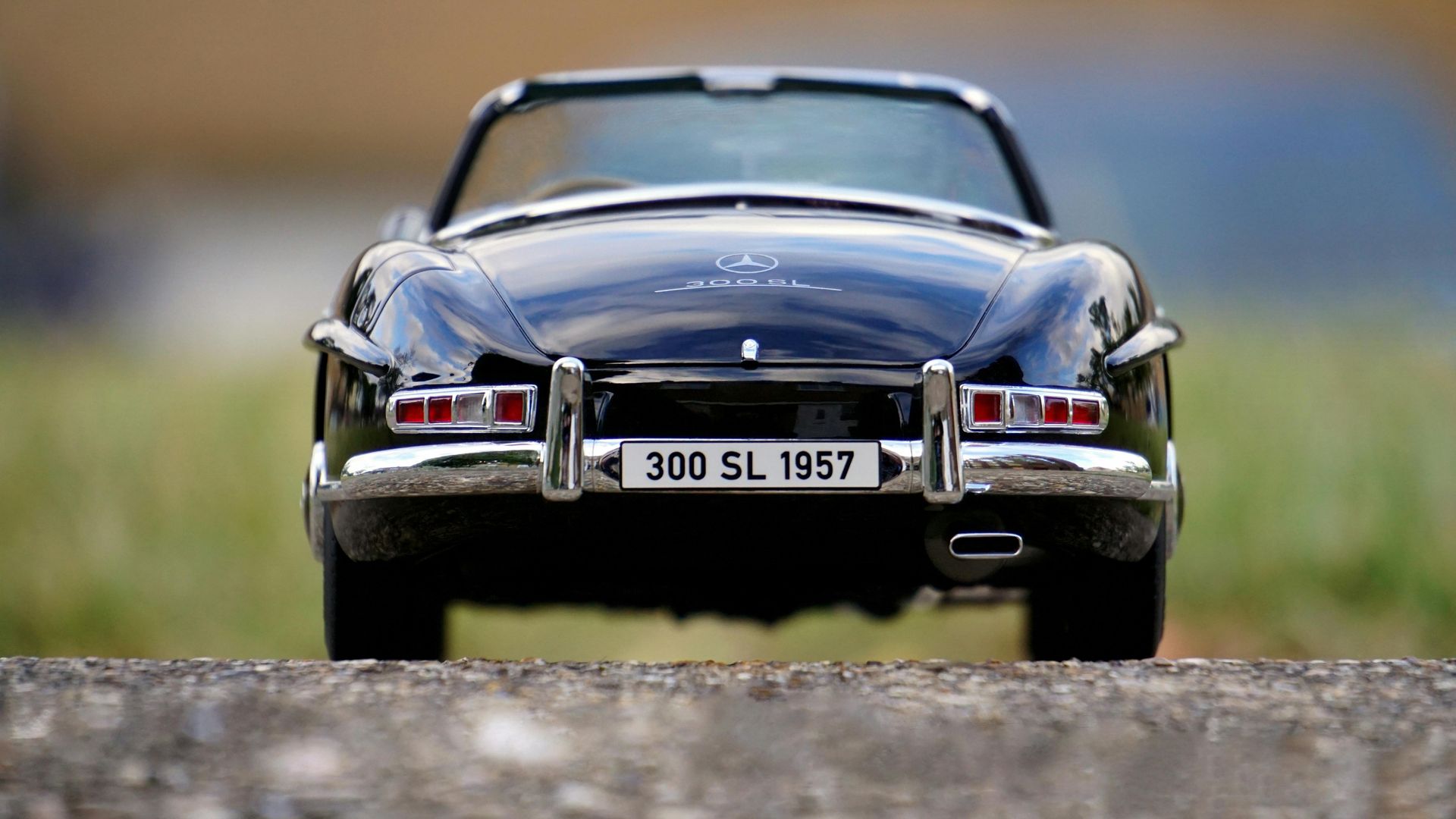 Black Mercedes 300 SL convertible model car with chrome accents, license plate 
