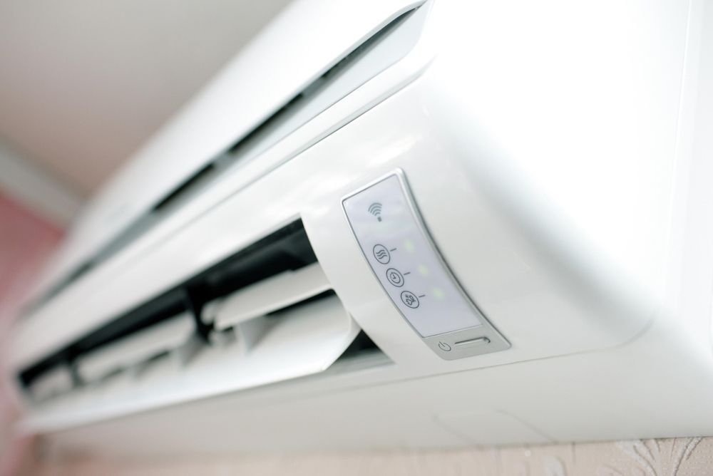 A Close up Of a White Air Conditioner on A Wall — Revive Air Conditioning in Campbelltown, NSW