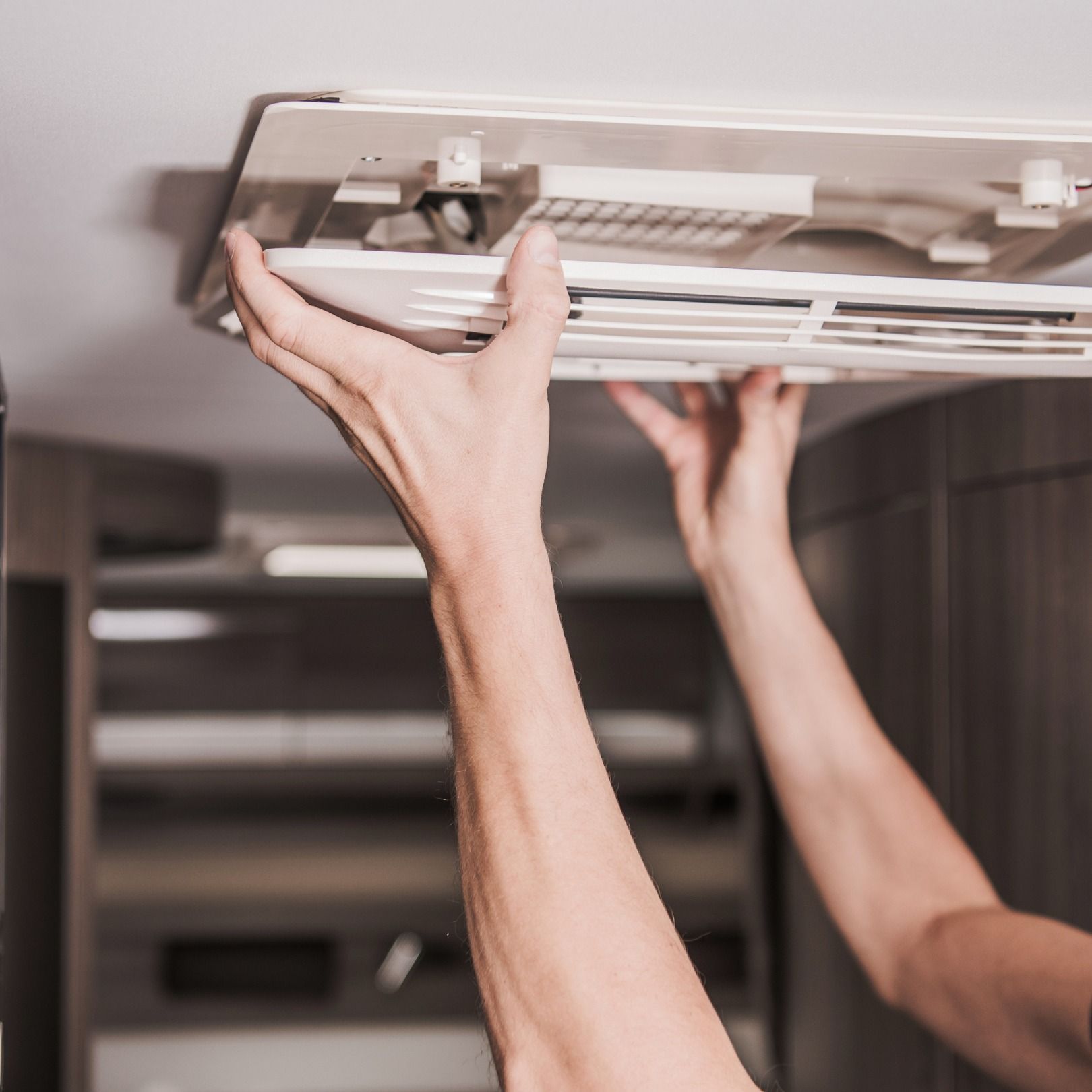 A Man Is Fixing ducted heating  — Revive Air Conditioning in Narellan, NSW