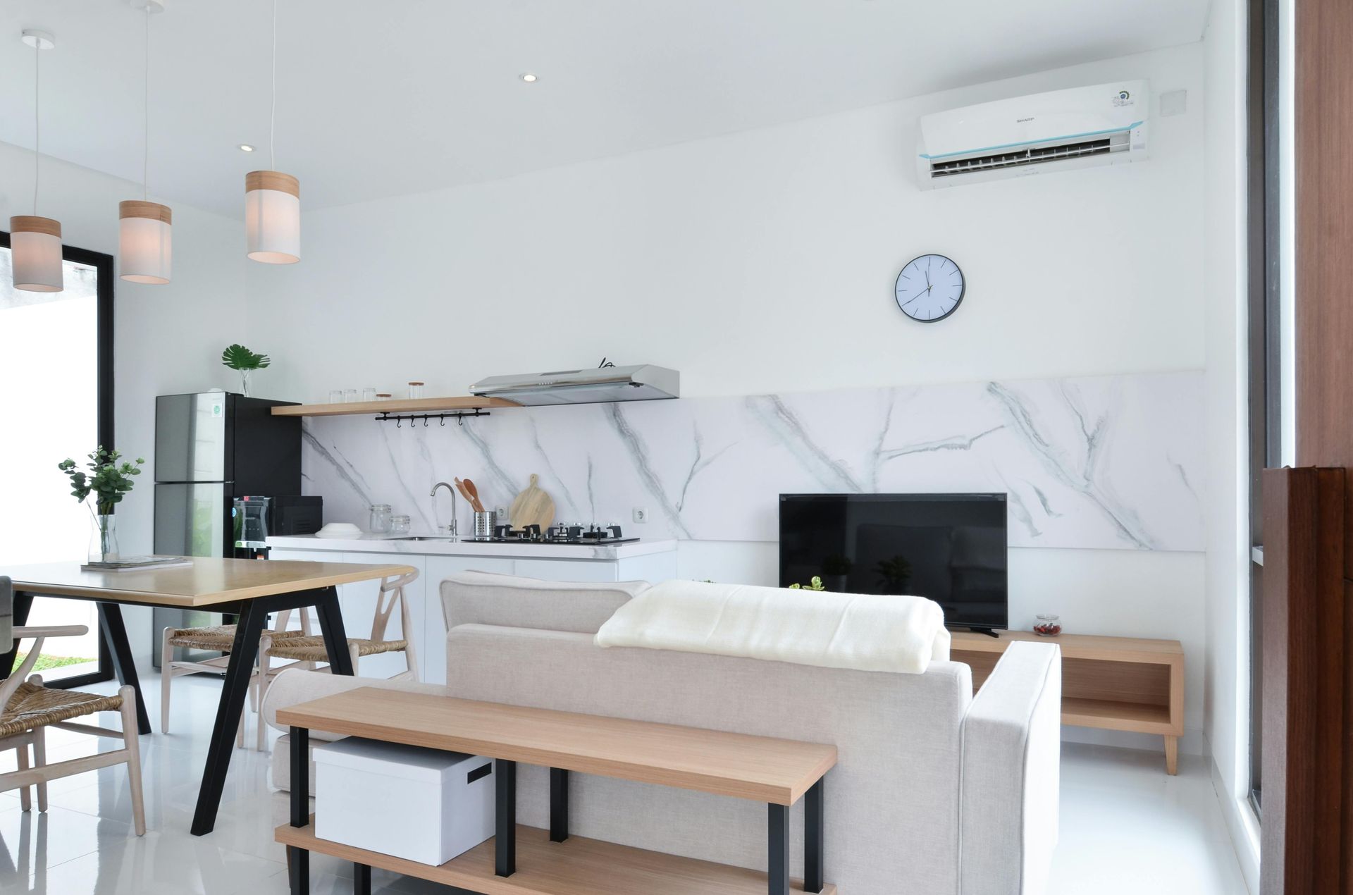 A Person is Holding a Dirty Air Filter in Front of an Air Conditioner — Revive Air Conditioning in Liverpool, NSW