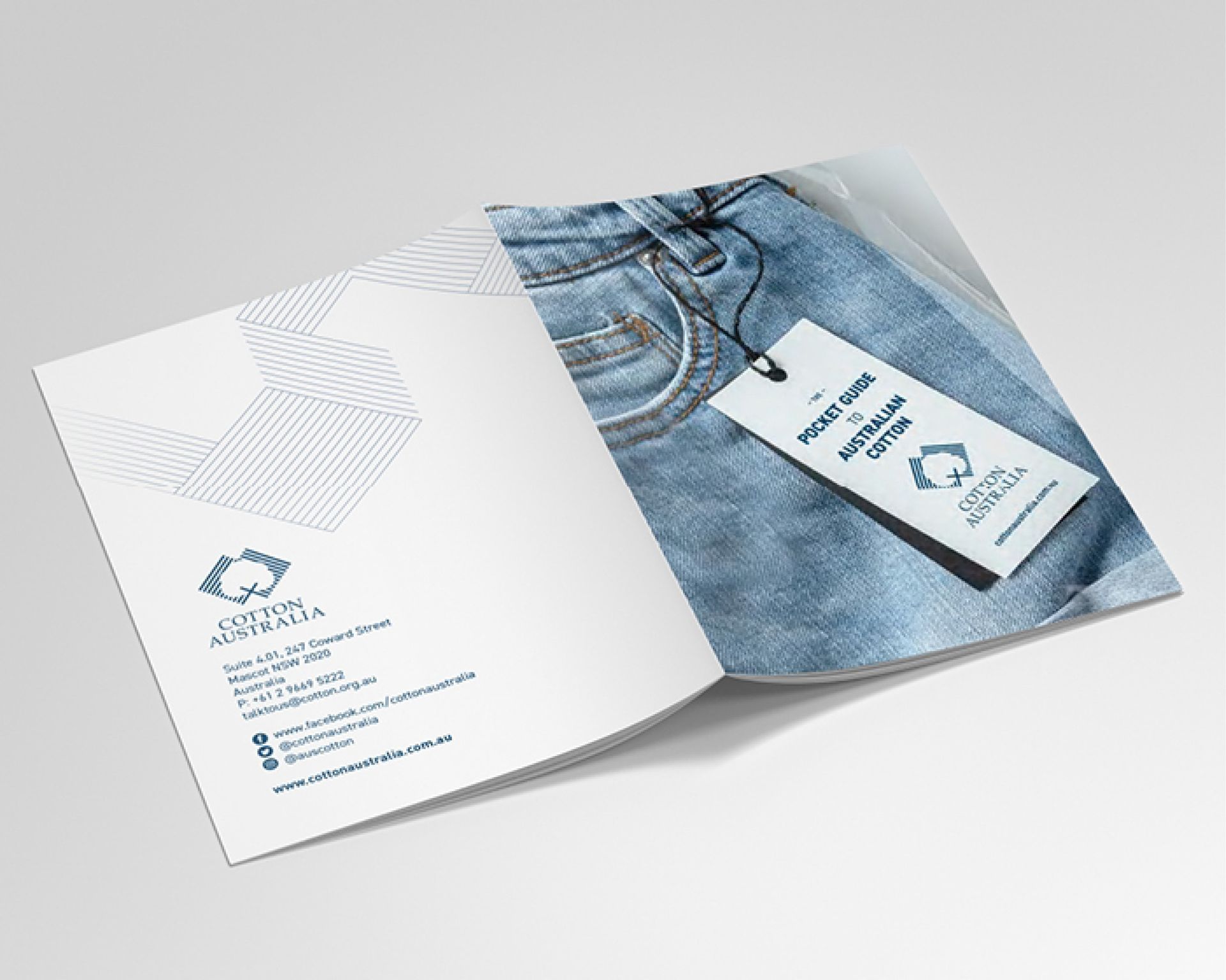 Open brochure with blue denim design and a white business card on the right page