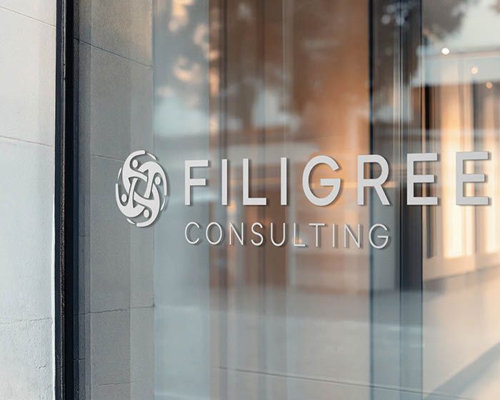 The logo for filigree consulting is on a glass window.