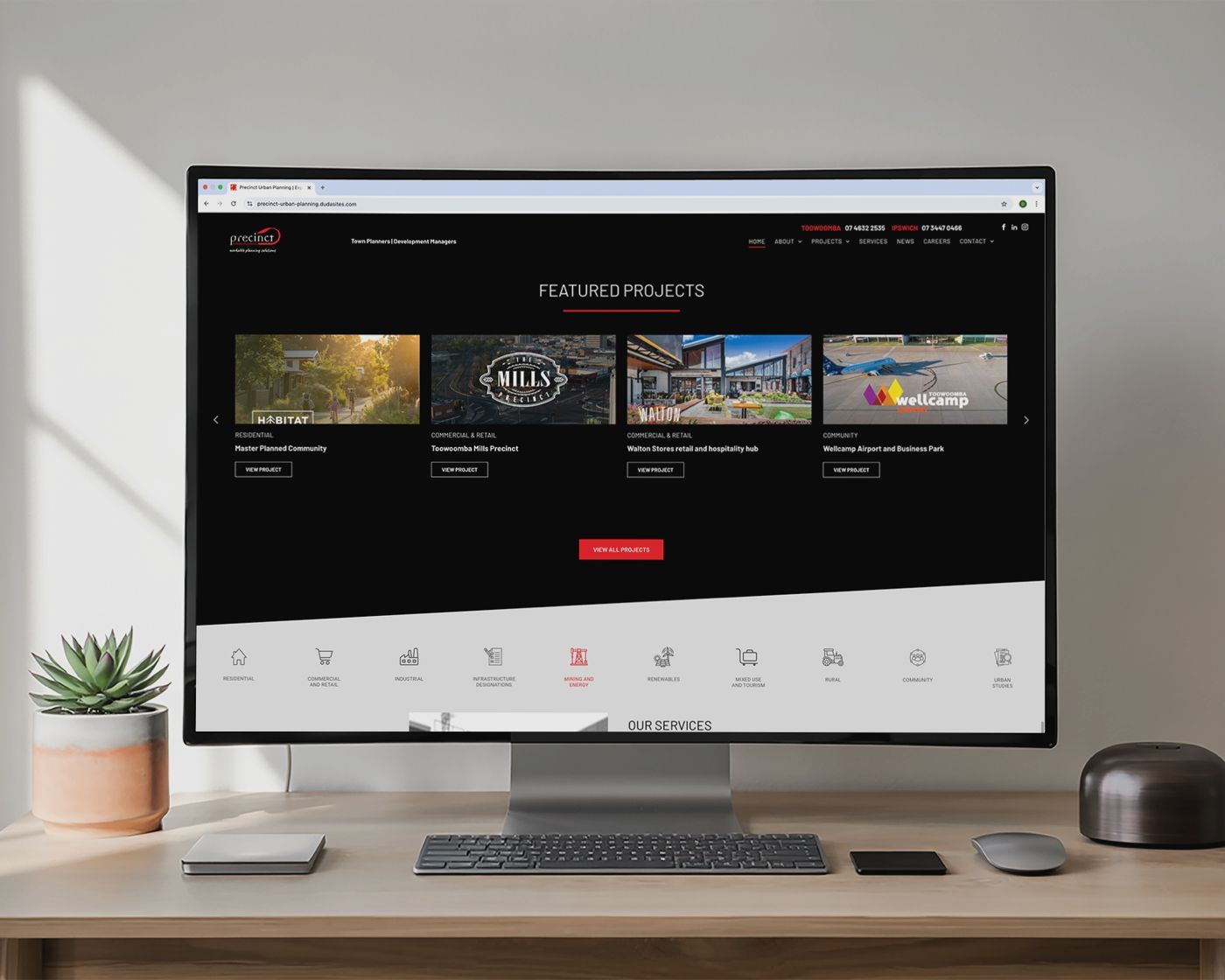 Desktop monitor displaying a dark-themed streaming website on a tidy desk