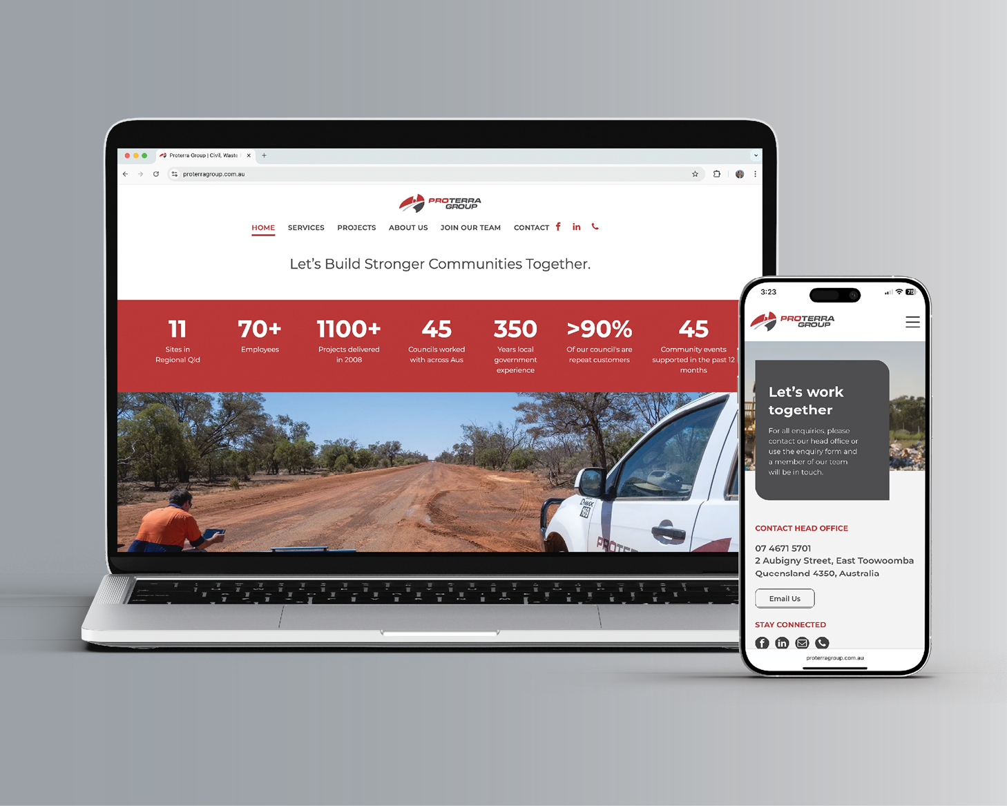 Laptop and smartphone showing a website with a red stats banner and road scene banner