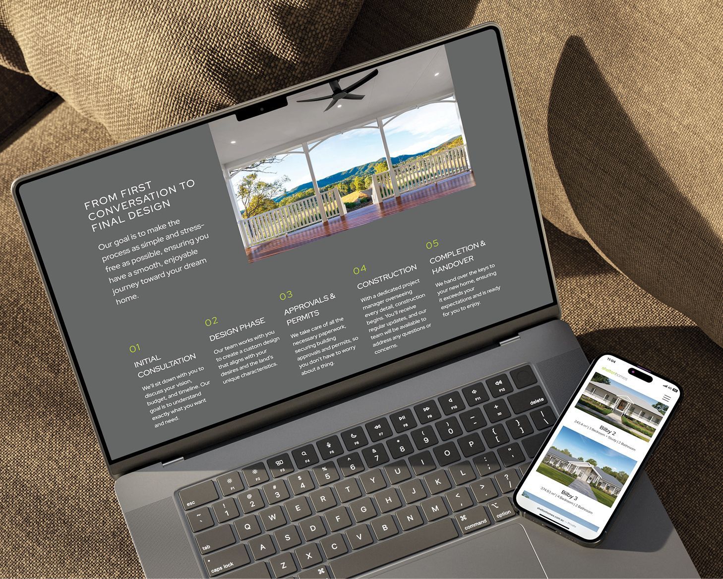 Laptop and smartphone displaying a travel website on a couch with a textured blanket background