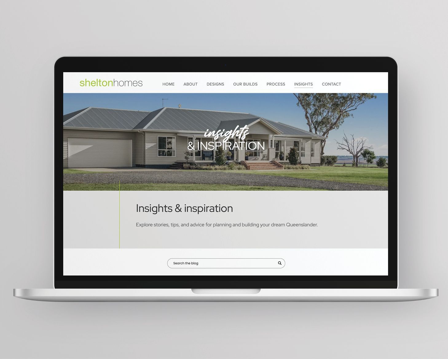 Laptop displaying a homebuilder website with a house hero image and “Inspire & Imagine” headline