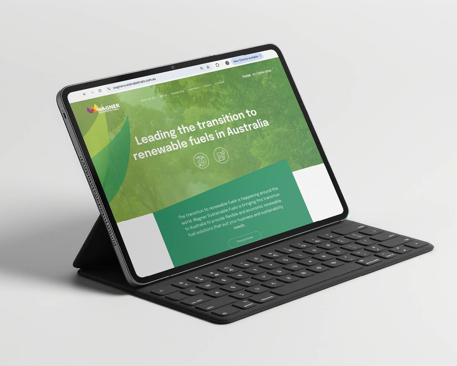 Tablet with keyboard case displaying a green website on a white background