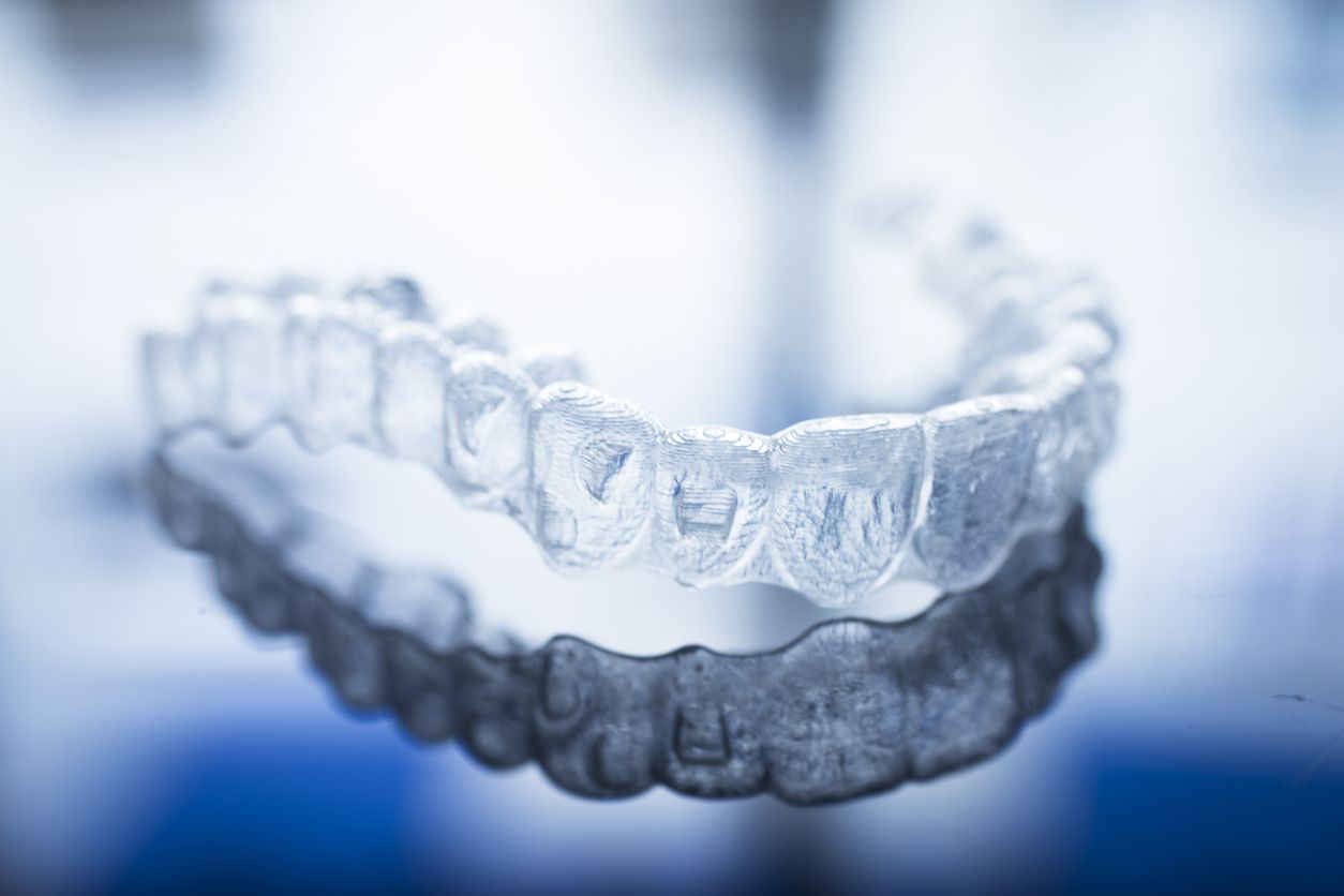 a close up of a clear brace on a blue surface 