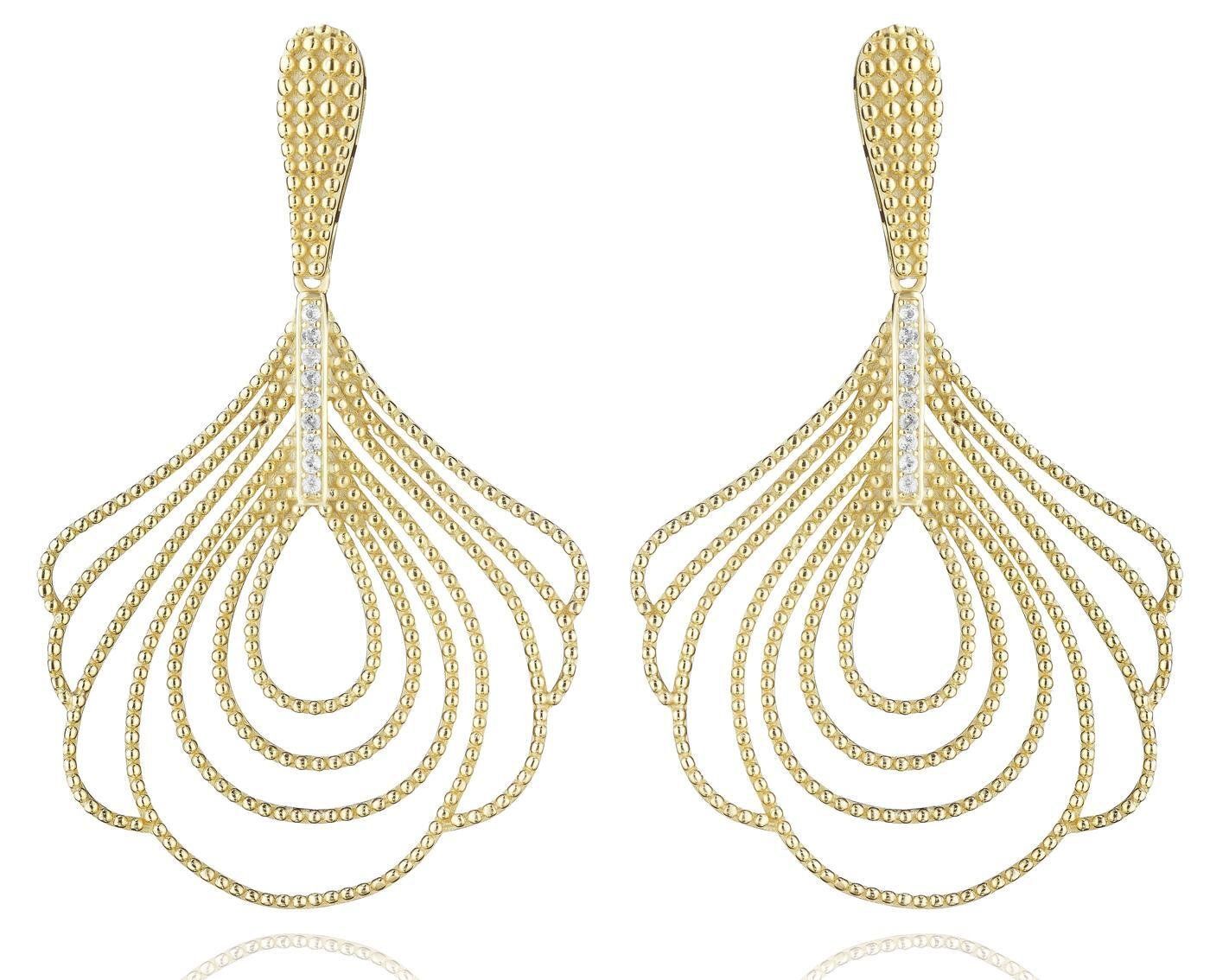 a pair of gold earrings on a white surface