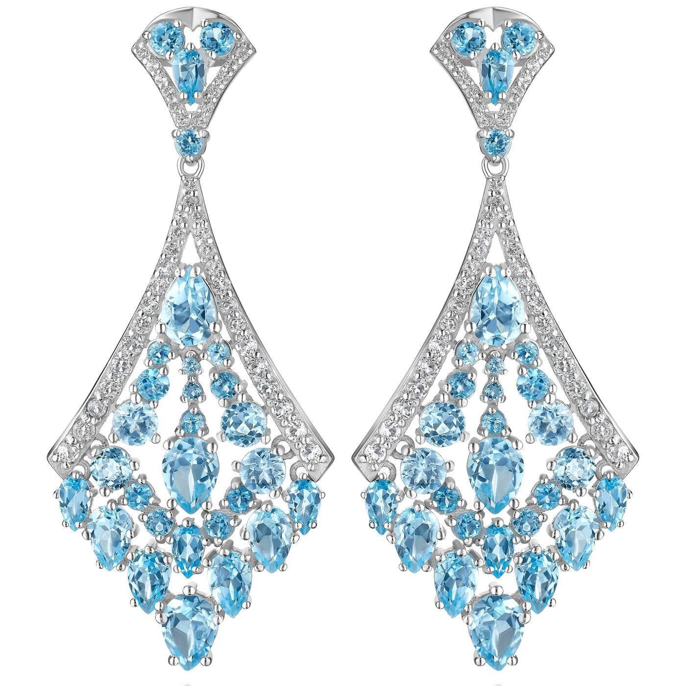 a pair of earrings with blue and white stones on a white background