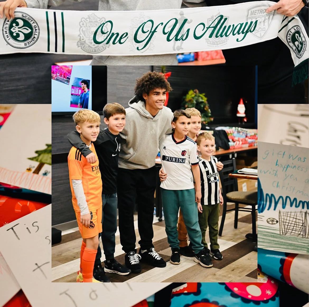 Youth soccer team posing indoors beneath a banner reading “One Of Us Always”