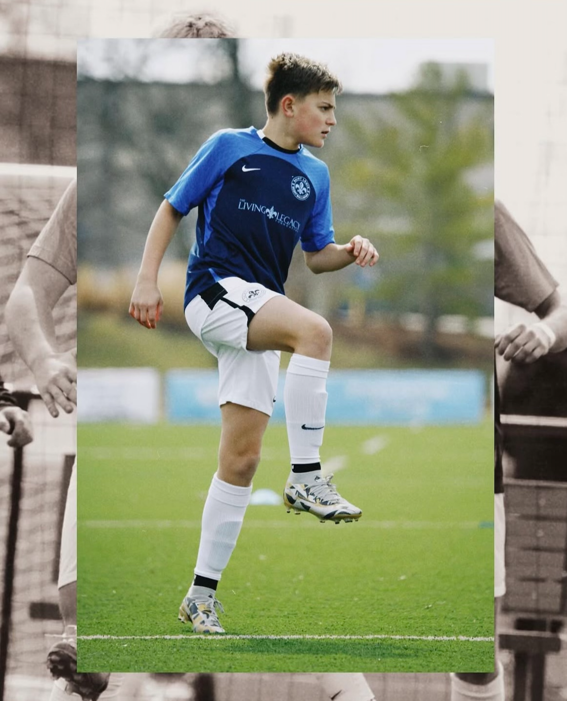 Soccer player in blue jersey and white socks lifting a knee on the field