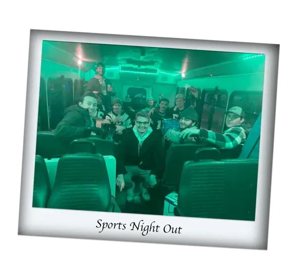 Group of people smiling on a green-lit bus at Sports Night Out.