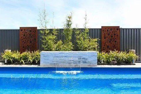 White block of fountain near pool — Inground Pools in Dubbo