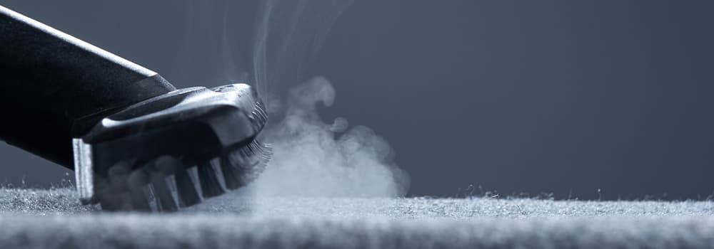 A Vacuum Cleaner is Cleaning a Carpet With Steam Coming Out of It — First Choice Cleaning Services in Wodonga, VIC