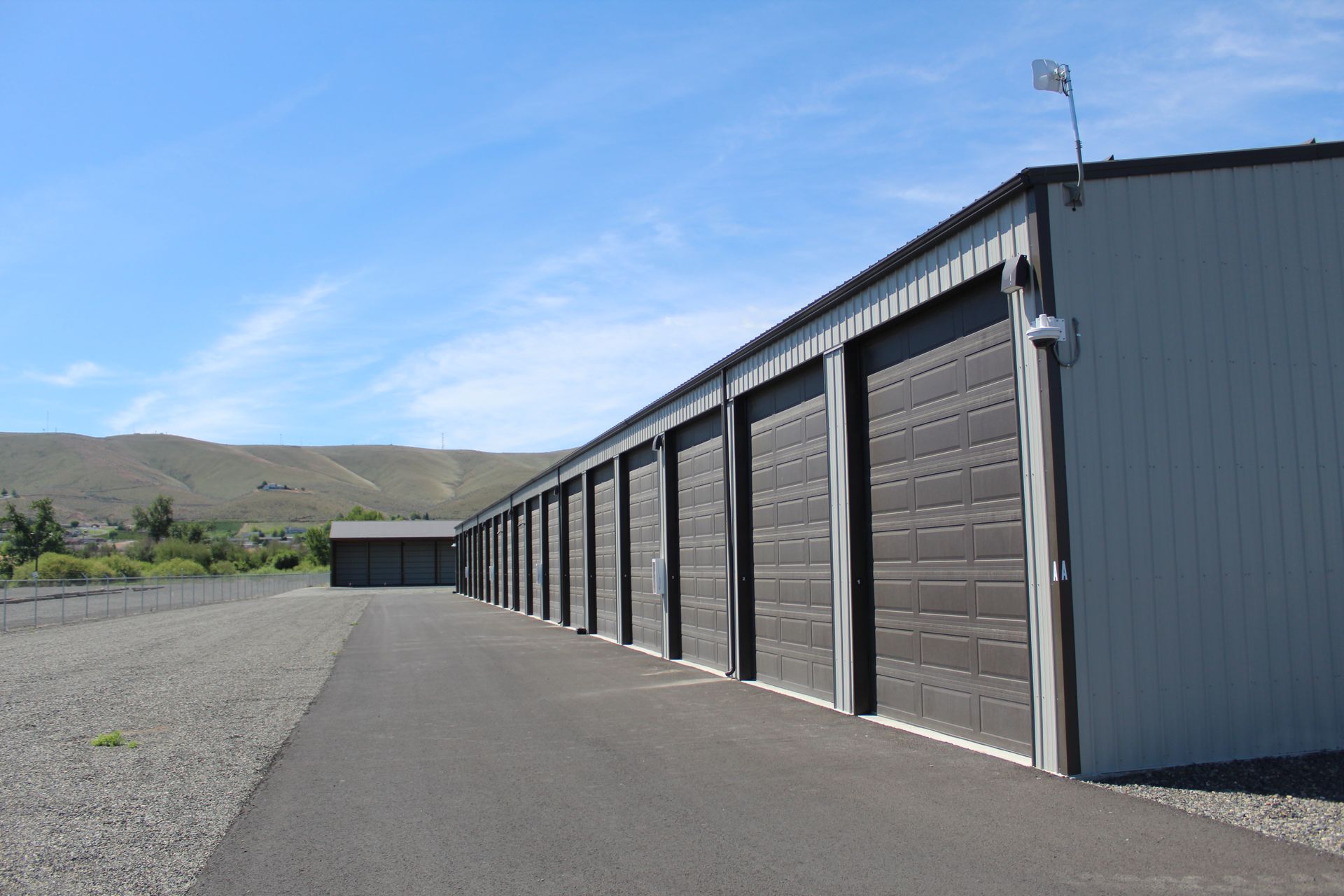 A row of storage units with a blue sky in the background