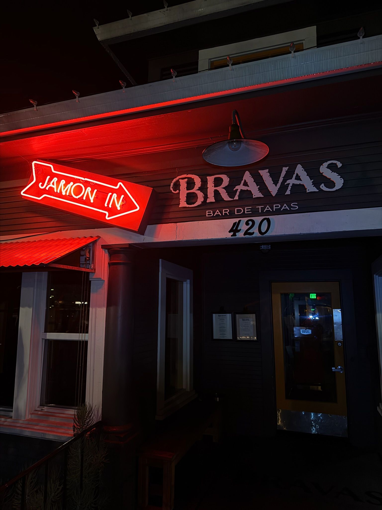 Neon sign for Bravas restaurant with 