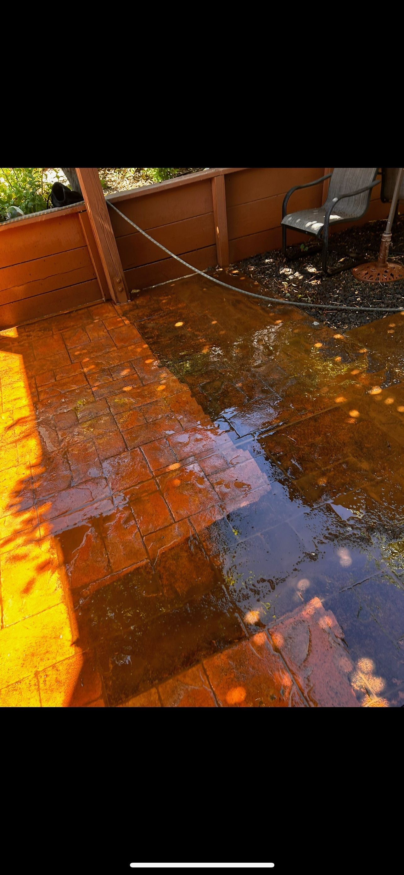 Deck flooded with murky, brown water. Wooden structure and steps are partially submerged.