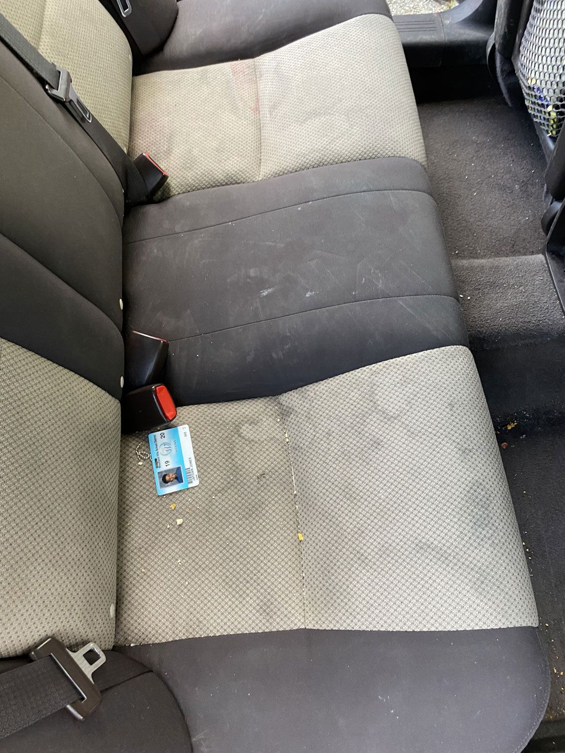 The back seat of a car with a badge on it.