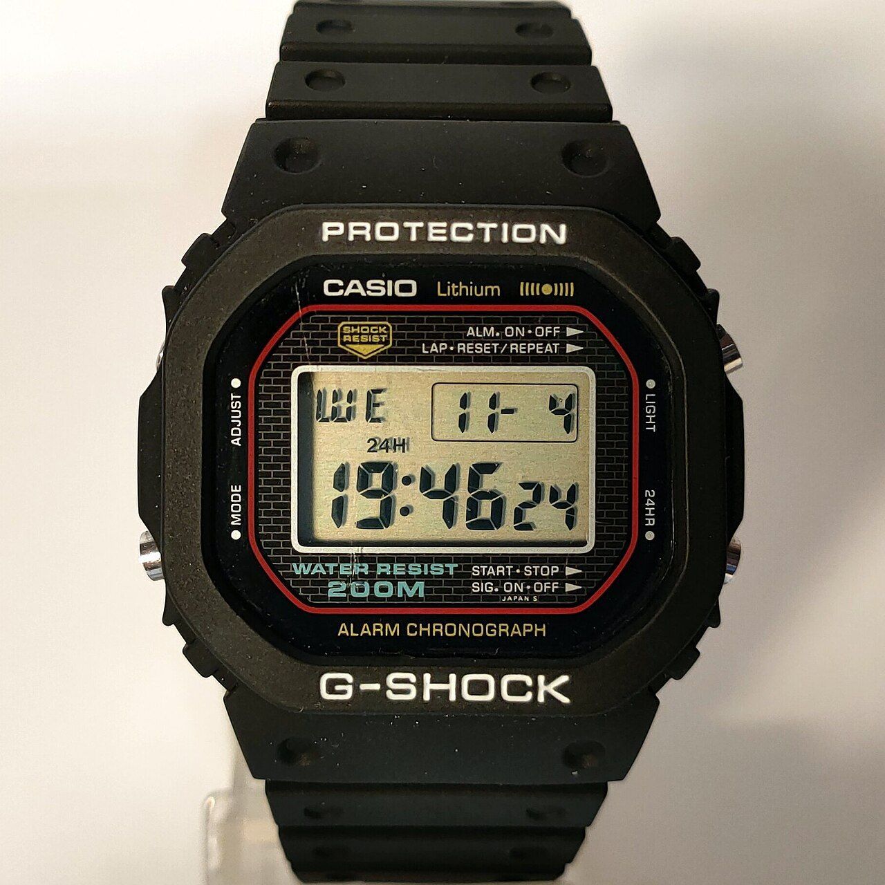 An original 1983 Casio G-Shock DW-5000C (module 240), the first G-Shock, with its square resin case and protective bezel.