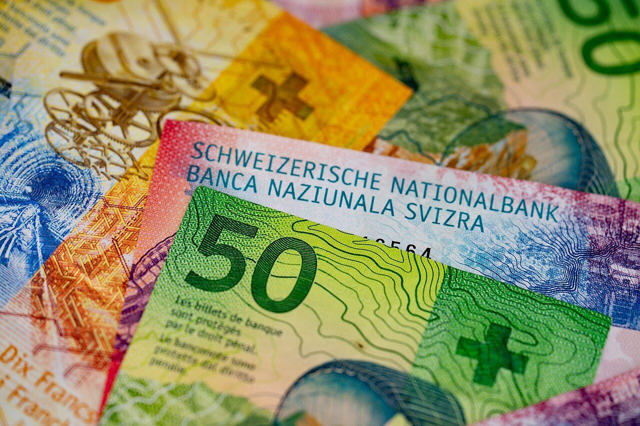 Swiss franc banknotes fanned out on a table