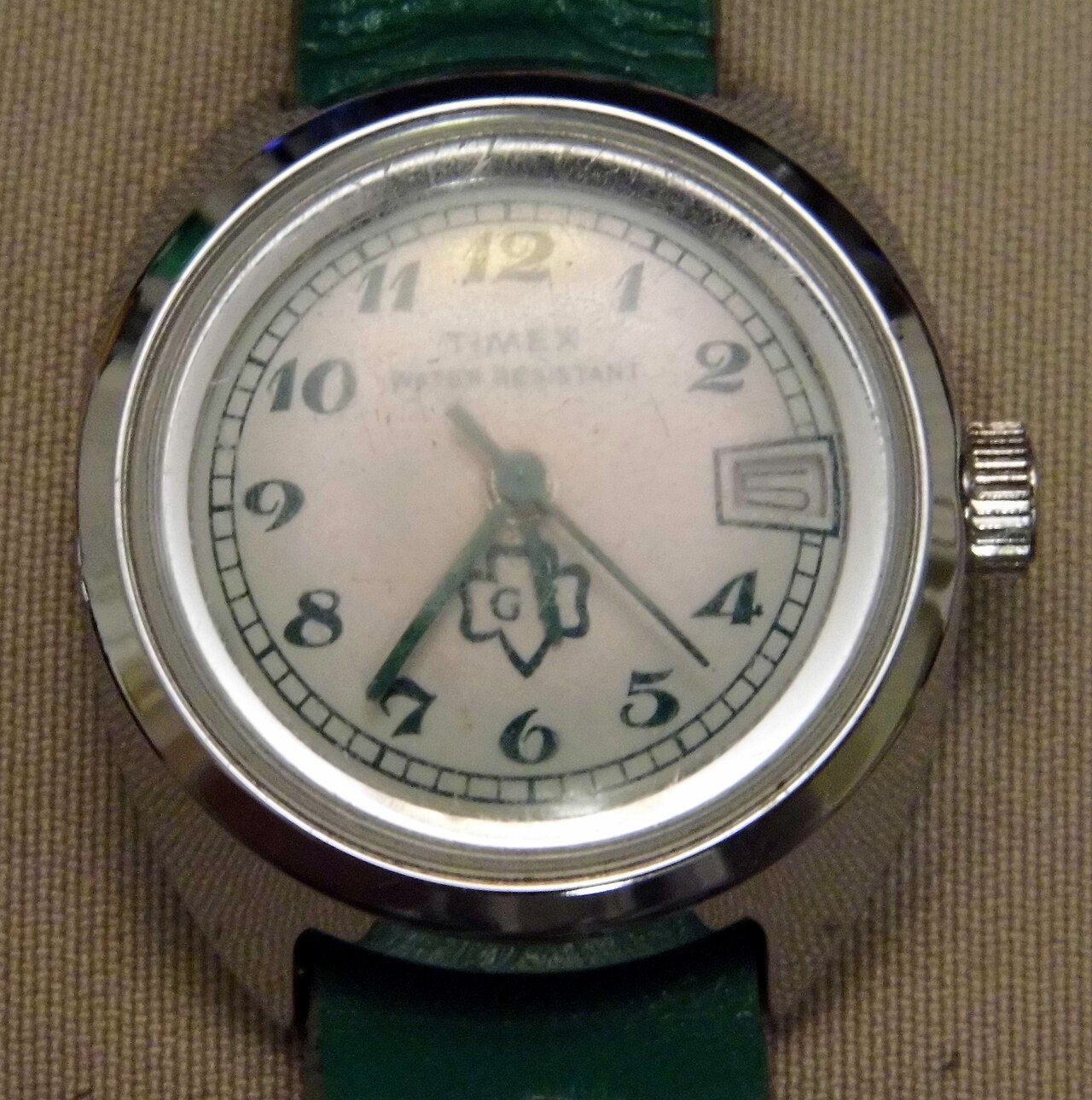 A vintage manual-wind Timex made for the Girl Scouts — typical of the inexpensive mechanical watches that made Timex ubiquitous in mid-century America.