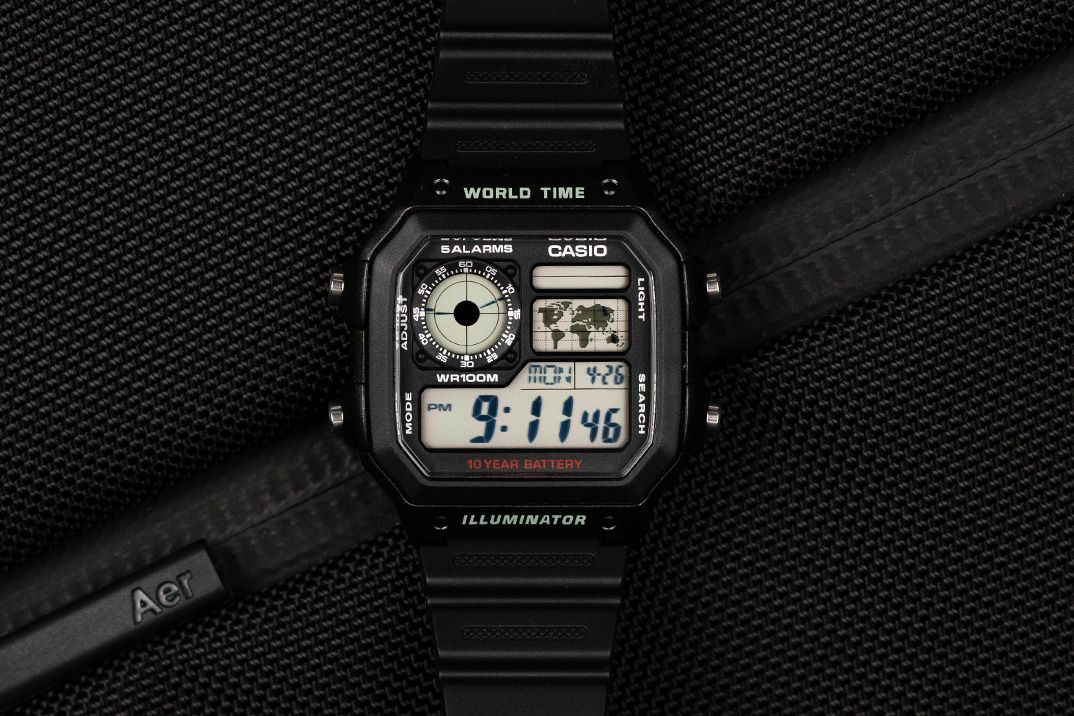 The Casio AE-1200WH, showing its world-map display, analogue-style home-time subdial and steel-look panel over a black resin case.