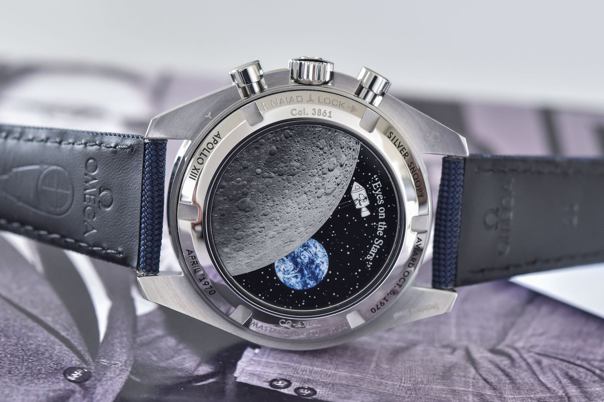 Caseback of the Omega Speedmaster Silver Snoopy Award 50th Anniversary showing the moon and Snoopy animation