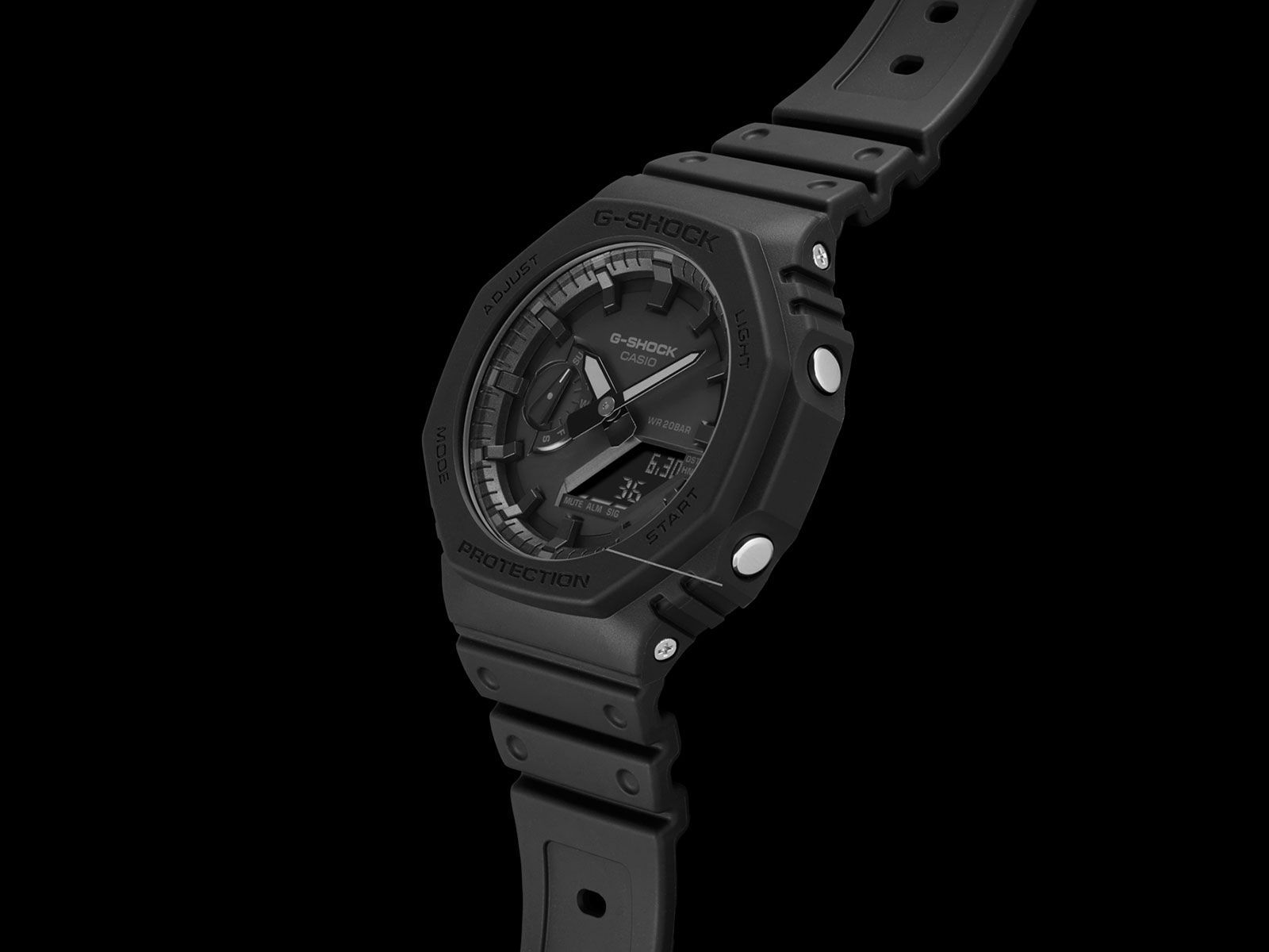 The G-Shock GA-2100 (2019), showing its octagonal bezel, analogue hands with digital displays, and resin case over the Carbon Core Guard structure.