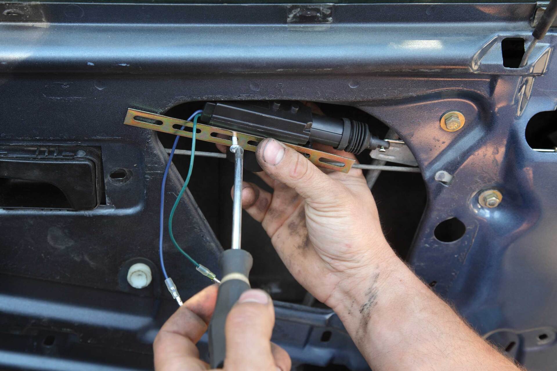 Mechanic Installing Car Door Lock Motor — Hutchinson, KS — Mobile Service Auto Glass