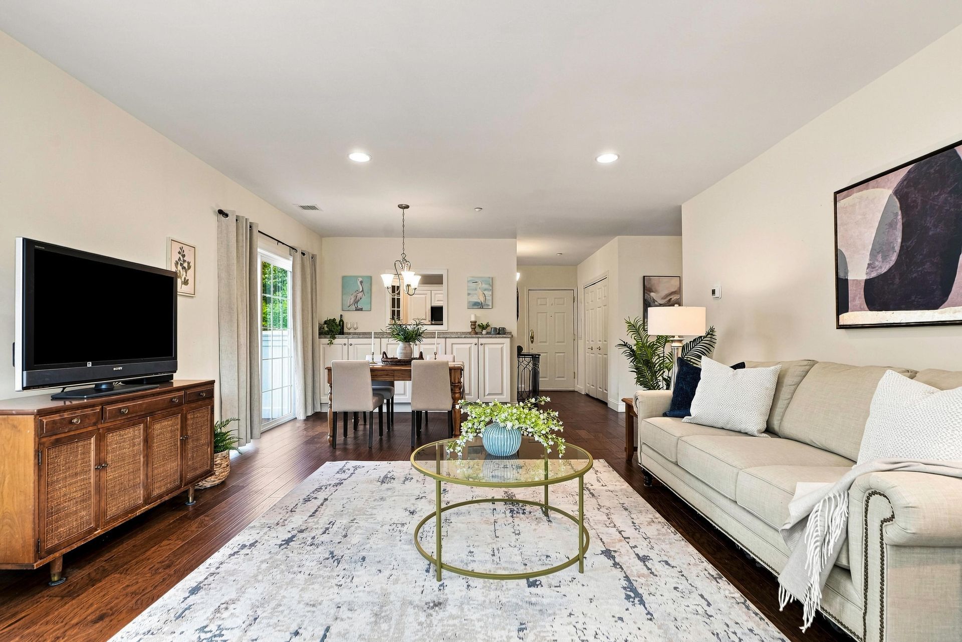 Open living and dining area with hardwood floors