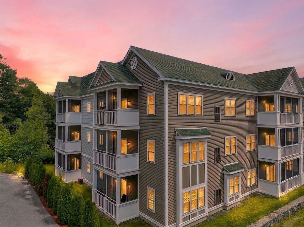 Clinton Woodlands condominium building at twilight, home of 2201 Briarwood Village in Clinton, MA