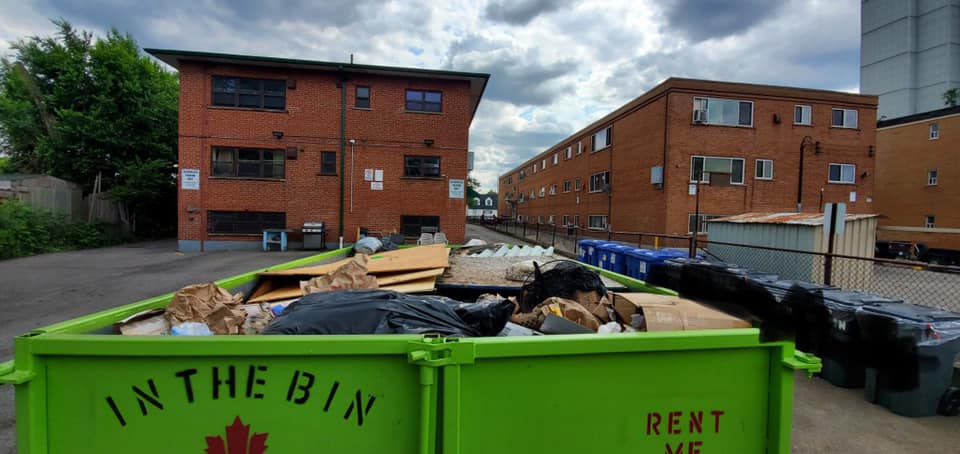 Green dumpster labeled