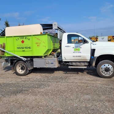 A green bin on top of a truck