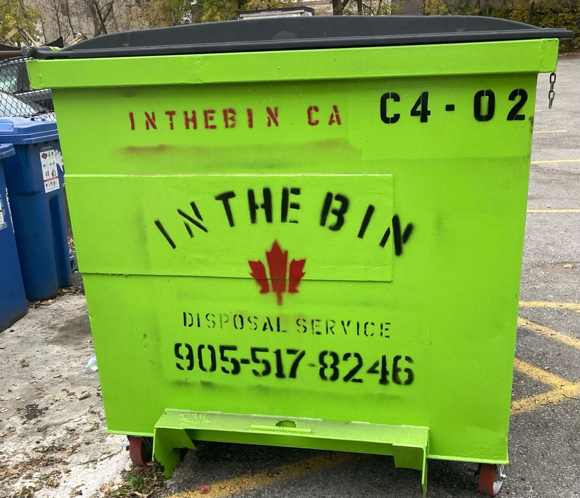 Bright green dumpster labeled